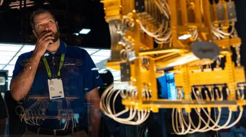 AFP via Getty Images A man looking at a quantum computer last week at a technology conference in Washington DC