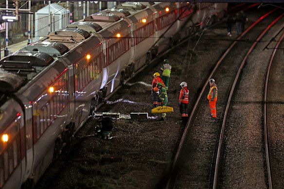 Emergency personnel on the tracks at Huntingdon train station in Cambridgeshire after the stabbing attack.