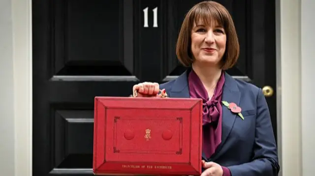 Rachel Reeves poses with the red Budget Box as she leaves 11 Downing Street