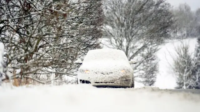 A snow-covered car in the North York Moors