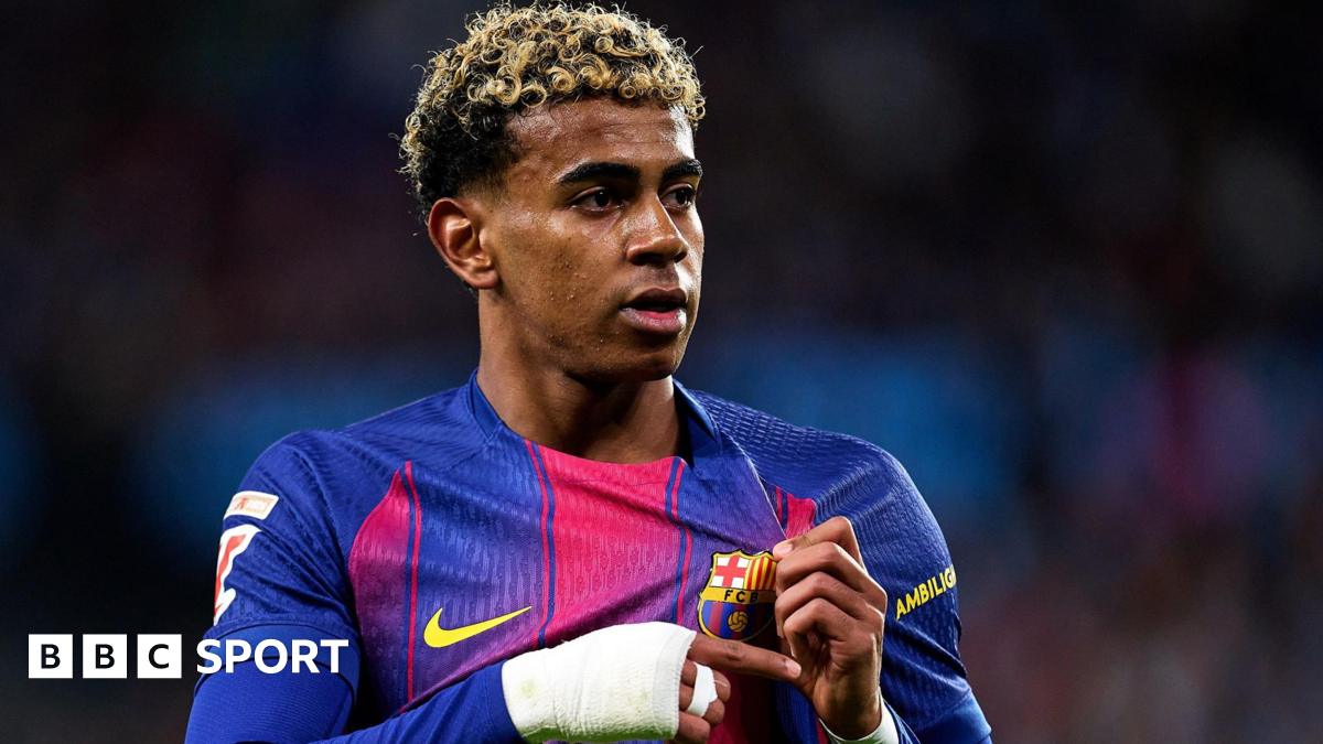 Lamine Yamal holds the Barcelona badge on his shirt