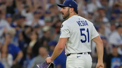 IMAGN IMAGES/Reuters Connect Vesia, wearing No 51 jersey, standing on pitchers' mound, holding his glove, and looking somber