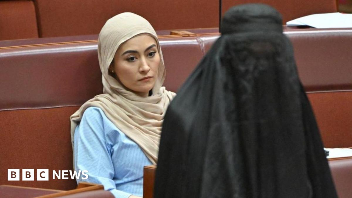 Independent senator Fatima Payman reacts as One Nation leader Pauline Hanson wears a burka in the Australian parliament
