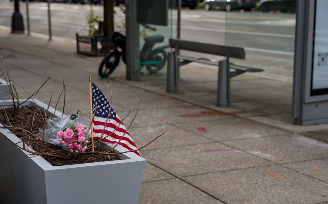 WASHINGTON, DC - NOVEMBER 27: A small memorial of flowers and an American flag has been set up outside the Farragut West Metro station on November 27, 2025 in Washington, DC. Two members of the West Virginia National Guard were shot on November 26 blocks from the White House in what authorities are calling a targeted shooting.   Andrew Leyden/Getty Images/AFP (Photo by Andrew Leyden / GETTY IMAGES NORTH AMERICA / Getty Images via AFP)