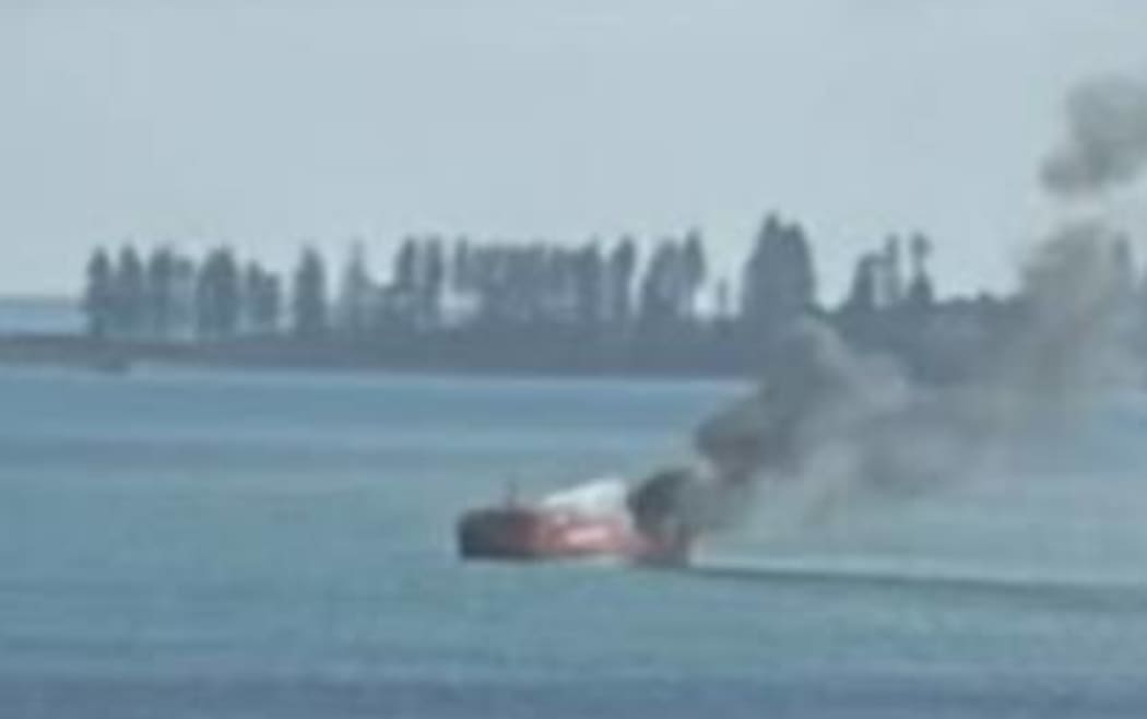 Launch on fire on Auckland's Hauraki Gulf, near Browns Island.