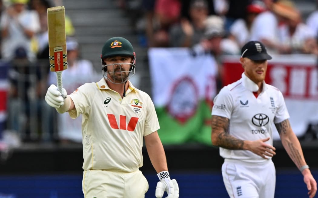 Australia’s Travis Head celebrates reaching his half century (50-runs) on day 2 of the first Ashes cricket Test match between Australia and England at Perth Stadium in Perth on 22 November, 2025.