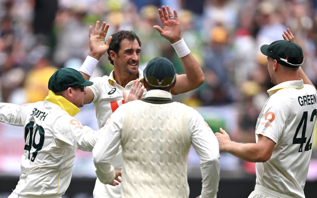 Australian bowler Mitchell Starc celebrates after dismissing England batsman Joe Root for 8 runs on Day 2 of the First Ashes Test between Australia and England at Perth Stadium