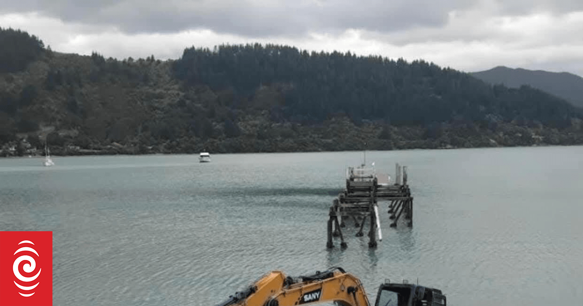 Digger goes for a swim at Waitaria Bay jetty
