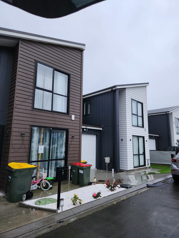 Ten townhouses on Purapura Lane in a Kumeu development don't have the fences, or trees in the original Resource Consent plans. Where there was meant to be soil and plantings, there is concrete and live cables underneath.