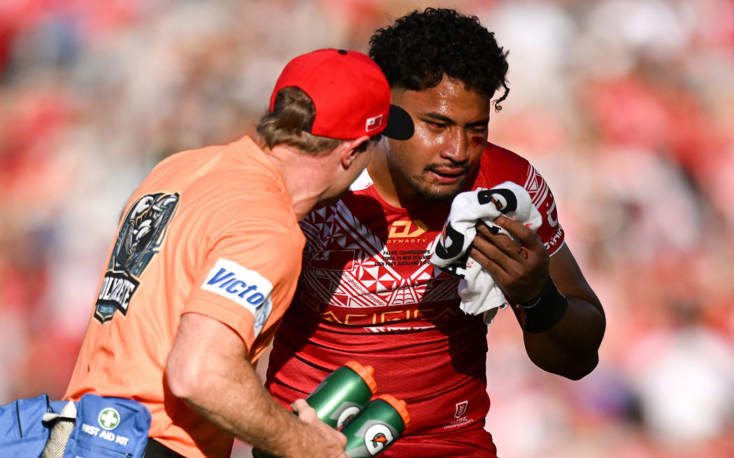 An injured Eliesa Katoa of Tonga is attended to by a trainer
New Zealand Kiwis v Tonga XIII Round 3 of the Pacific Championships rugby league tournament at Eden Park, Auckland