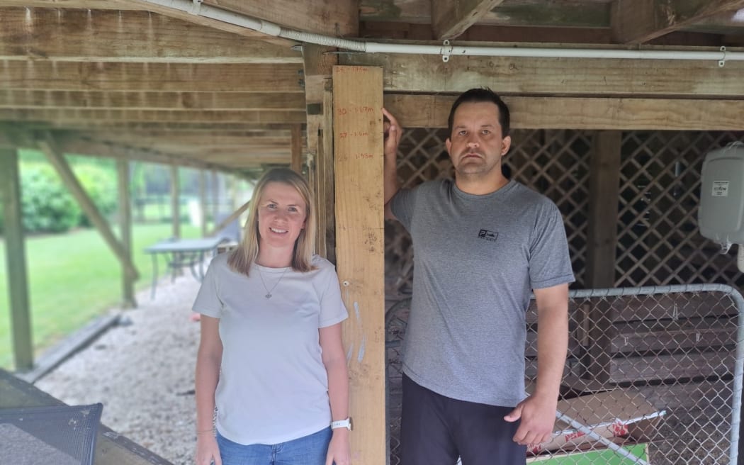 Brendon and Stephanie Deacon at their property that was considered category one by Auckland Council despite their neighbours all being category three following flooding.