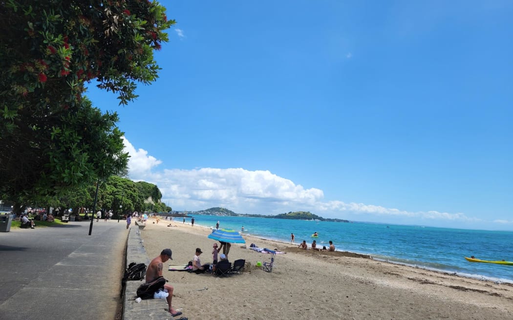 Sun lovers enjoying the sand and sun at Mission Bay in Auckland, 29/12/22