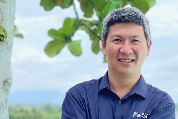 Man smiling with nature background behind
