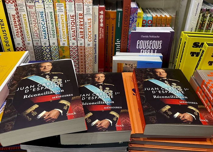 Books titled about Former King Juan Carlos on a store shelf, relating to how he took his brother's life.