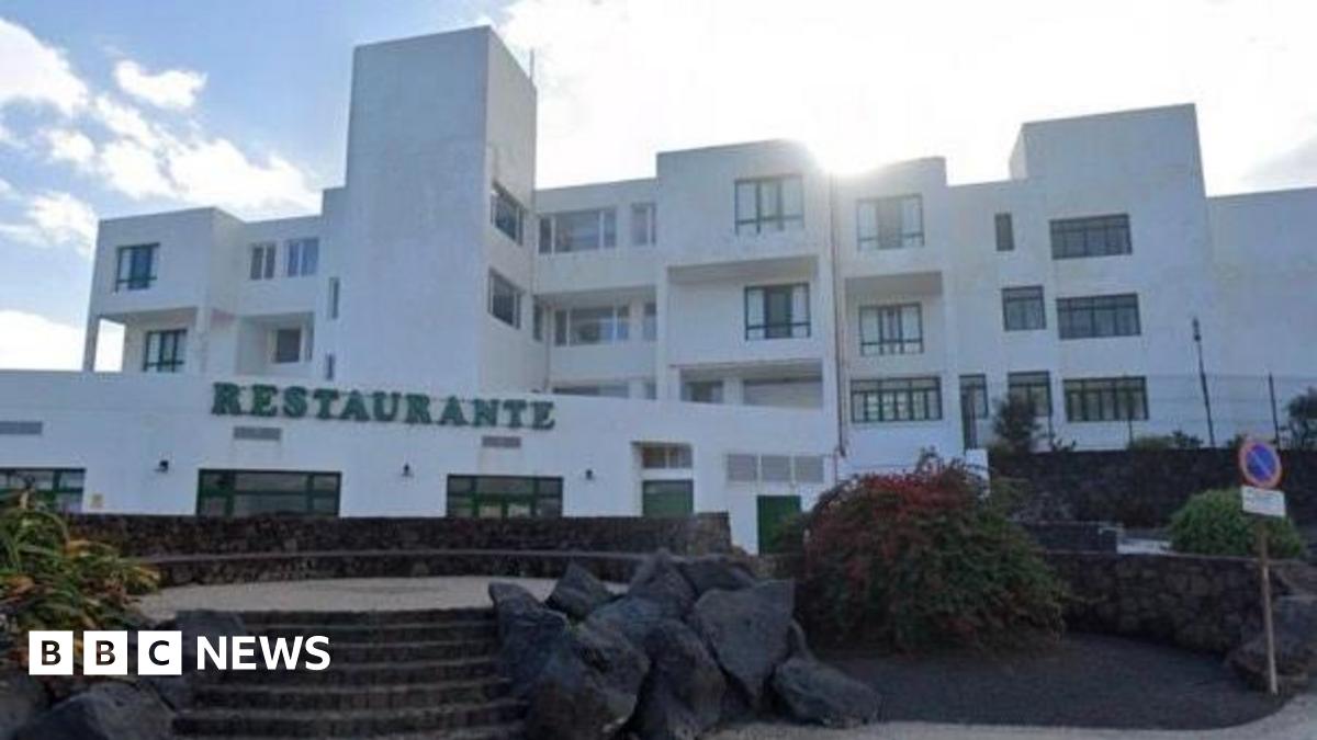The outside of the Galeon Playa apartments with a sign for a restaurant seen in the foreground.