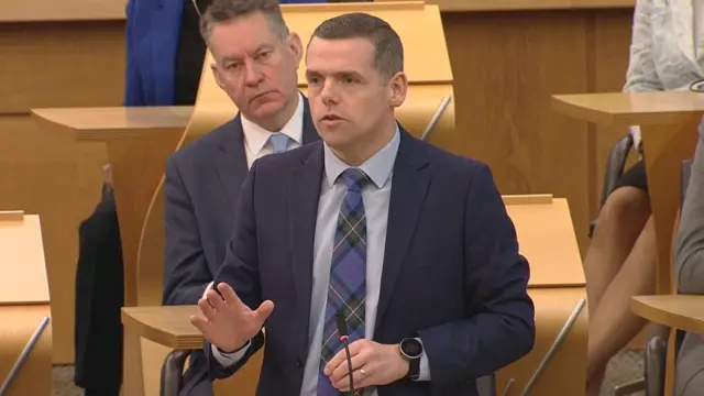 Douglas Ross stands in Scottish parliament
