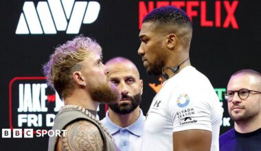 Anthony Joshua towers over Jake Paul during a face-off to promote their December heavyweight fight
