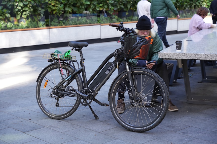 Photos of an e-bike, some delivery food e-bikes, in the Parramatta CBD on a sunny day.