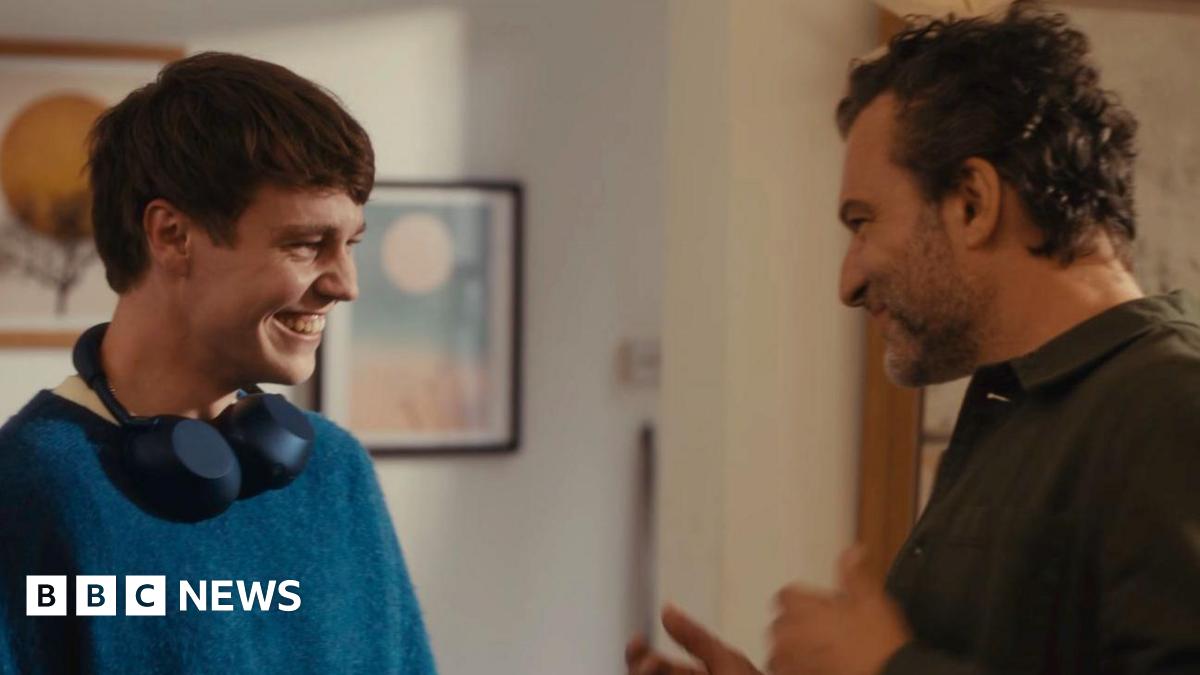 A son and father looking at each other and smiling in the John Lewis advert