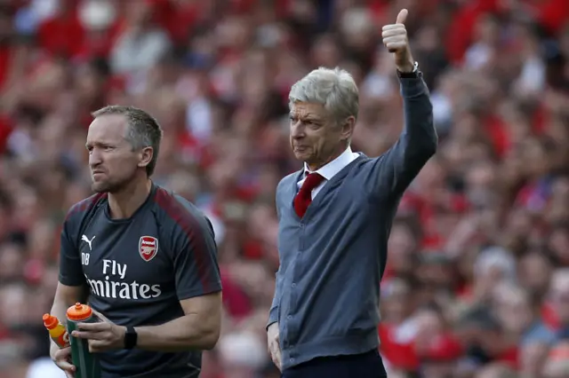 Arsene Wenger gives a thumbs up from the touchline during his time as Arsenal manager