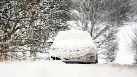 Danny Lawson/PA Wire A snow covered car on the A169 between Pickering and Whitby on the North York Moors