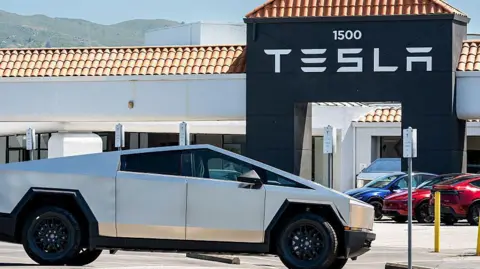 Bloomberg via Getty Images A cyber truck outside a Tesla plant