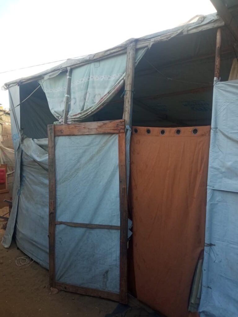 Tent shelter open and vulnerable to the elements.