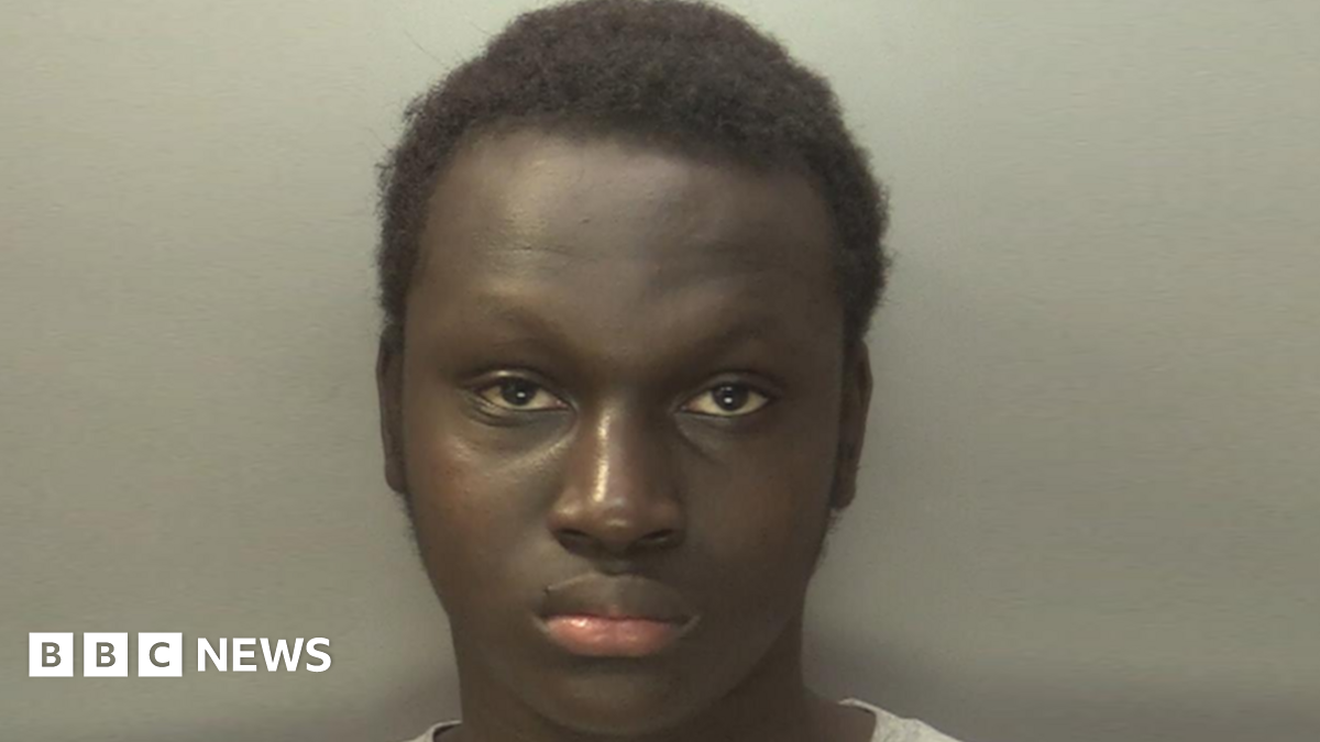 Middle age single mother with funny suffering tired face sit on couch in living room together with her fighting little sons