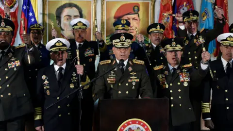 Getty Images Venezuelan Defence Minister Vladimir Padrino López (centre) holds a press conference in Caracas with army generals in support of Nicolás Maduro on 24 January 2019.