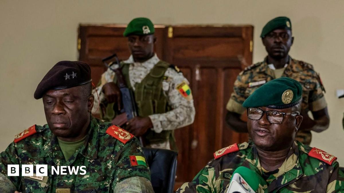 Soldiers wearing military fatigues make an address