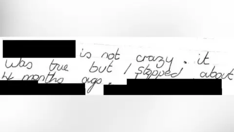 CPS The letter written by David Carrick. In black ink, it reads: "Is not crazy. It was true but I stopped about 4 months ago". Several parts, including the first word, are redacted to protect the victim's identity.