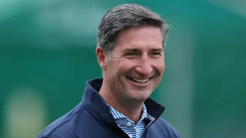 Getty Images Starbucks CEO Brian Niccol with a sweater with a popped collar and blue striped button up shirt on May 28, 2025 in Dublin, Ohio.