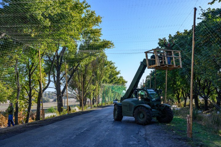 Workers repair anti-drone nets covering roads to block Russian attack drones in Donetsk region, Ukraine, September 24, 2025. (Source: Getty Images)