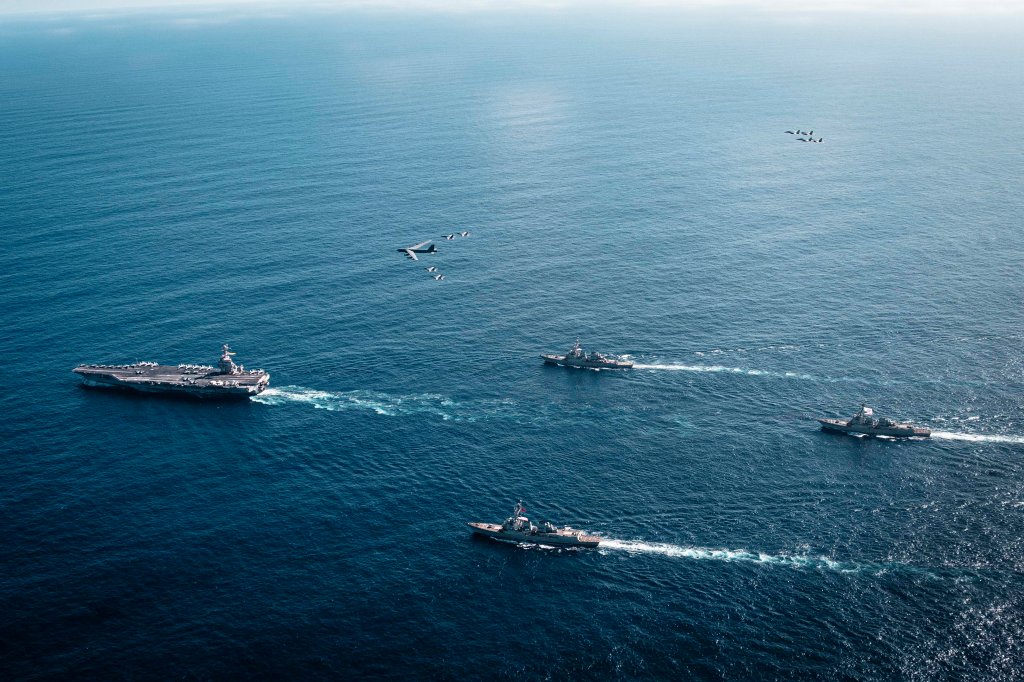 The U.S. Navy’s Gerald R. Ford Carrier Strike Group, including the flagship USS Gerald R. Ford (CVN 78), left, USS Winston S. Churchill (DDG 81), front, USS Mahan (DDG 72), back, USS Bainbridge (DDG 96), and embarked Carrier Air Wing Eight F/A-18E/F Super Hornets assigned to Strike Fighter Squadrons 31, 37, 87, and 213, operates as a joint, multi-domain force with a U.S. Air Force B-52 Stratofortress, Nov. 13, 2025. U.S. military forces, like the Gerald R. Ford Carrier Strike Group, are deployed in support of the U.S. Southern Command mission, Department of War-directed operations, and the President’s priorities to disrupt illicit drug trafficking and protect the homeland.