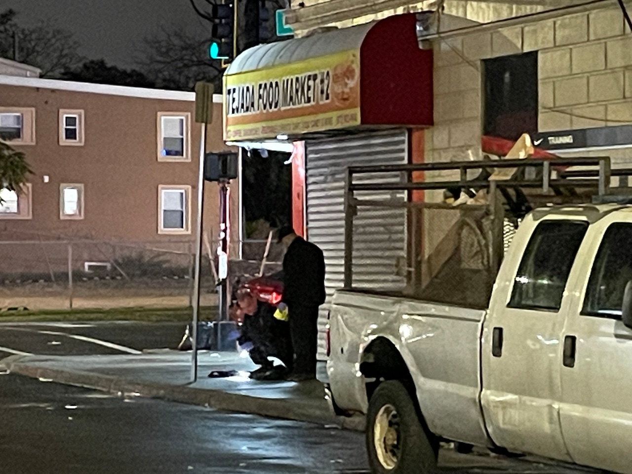 Investigators examine clothing on the sidewalk near the scene of a fatal shooting in Newark's South Ward, Saturday, Nov. 15, 2025.