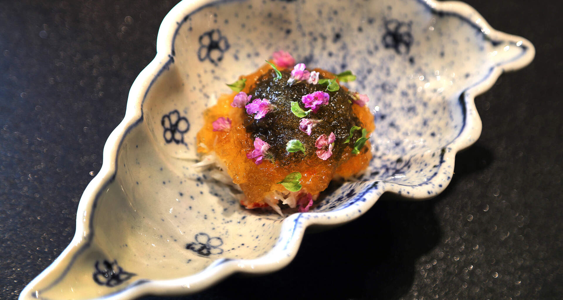 Kegani, horsehair crab from Hokkaido, is served with caviar, jelly in a white, shell-shaped dish traced with blue flowers at 311 Omakase in the South End.  (John Tlumacki/The Boston Globe via Getty Images)