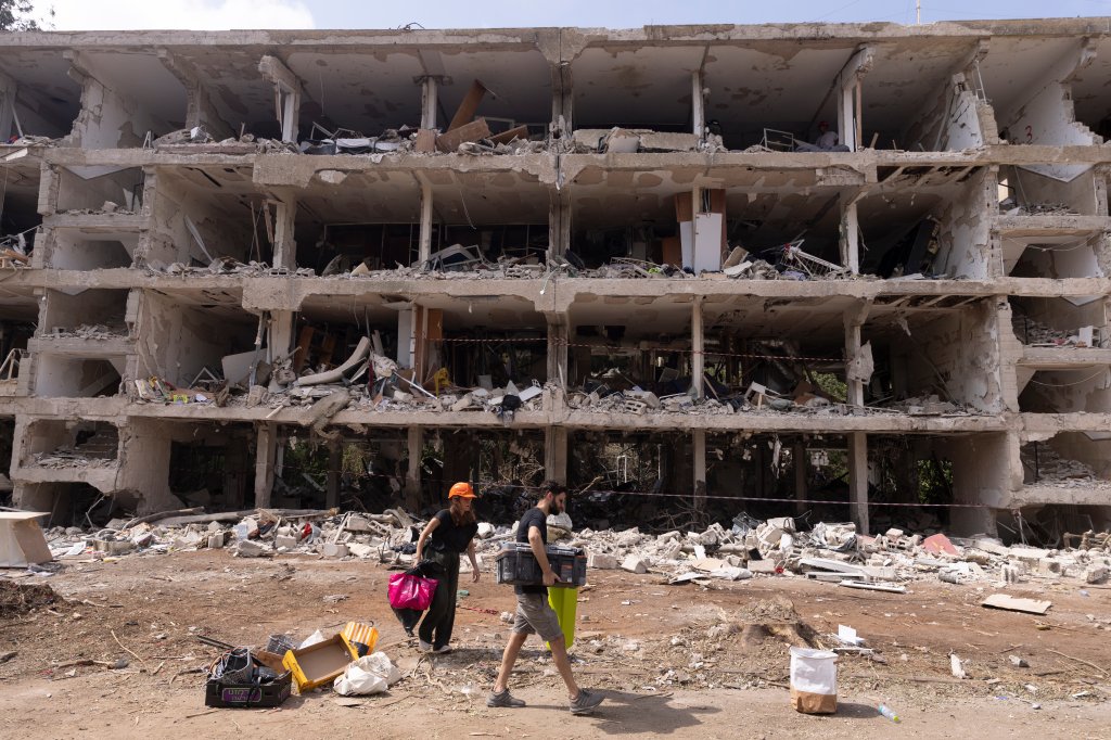 TEL AVIV, ISRAEL - JUNE 23: Civilians retrieve personal belongings from the rubble of their house after a ballistic missile fired from Iran struck the city yesterday morning on June 23, 2025 in Tel Aviv, Israel. Iran and Israel have continued to exchange aerial attacks in the days after the United States bombed several Iranian nuclear sites. (Photo by Amir Levy/Getty Images)