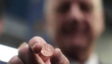 U.S. Treasurer Brandon Beach holds one of the last pennies pressed at the U.S. Mint in Philadelphia.