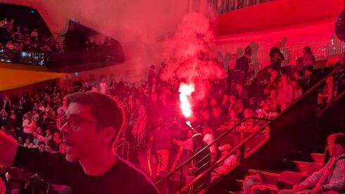 Protester lights flare during Israel Philharmonic performance in France