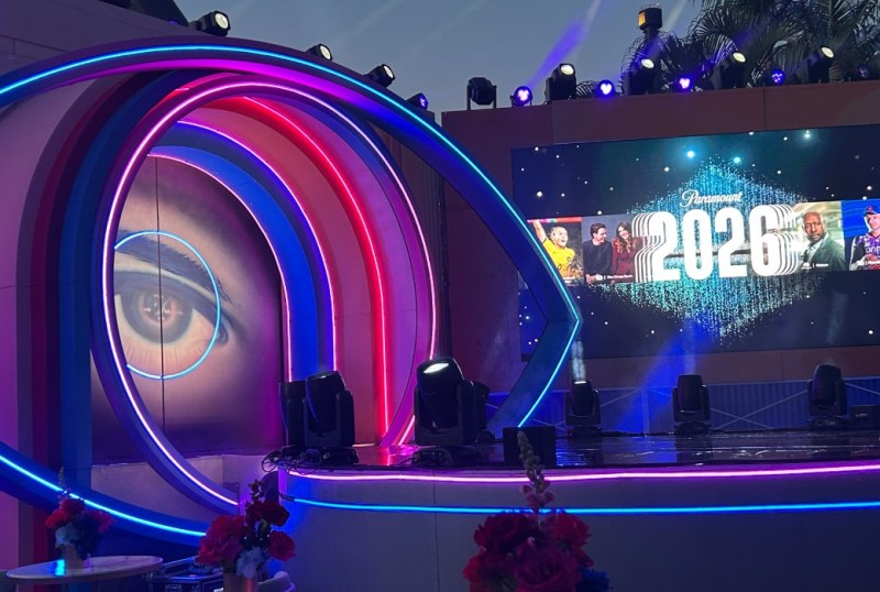 Stage setup for a 2026 event featuring a large eye graphic and vibrant lighting, with a digital display showcasing Paramount's 2026 branding and images of featured personalities.
