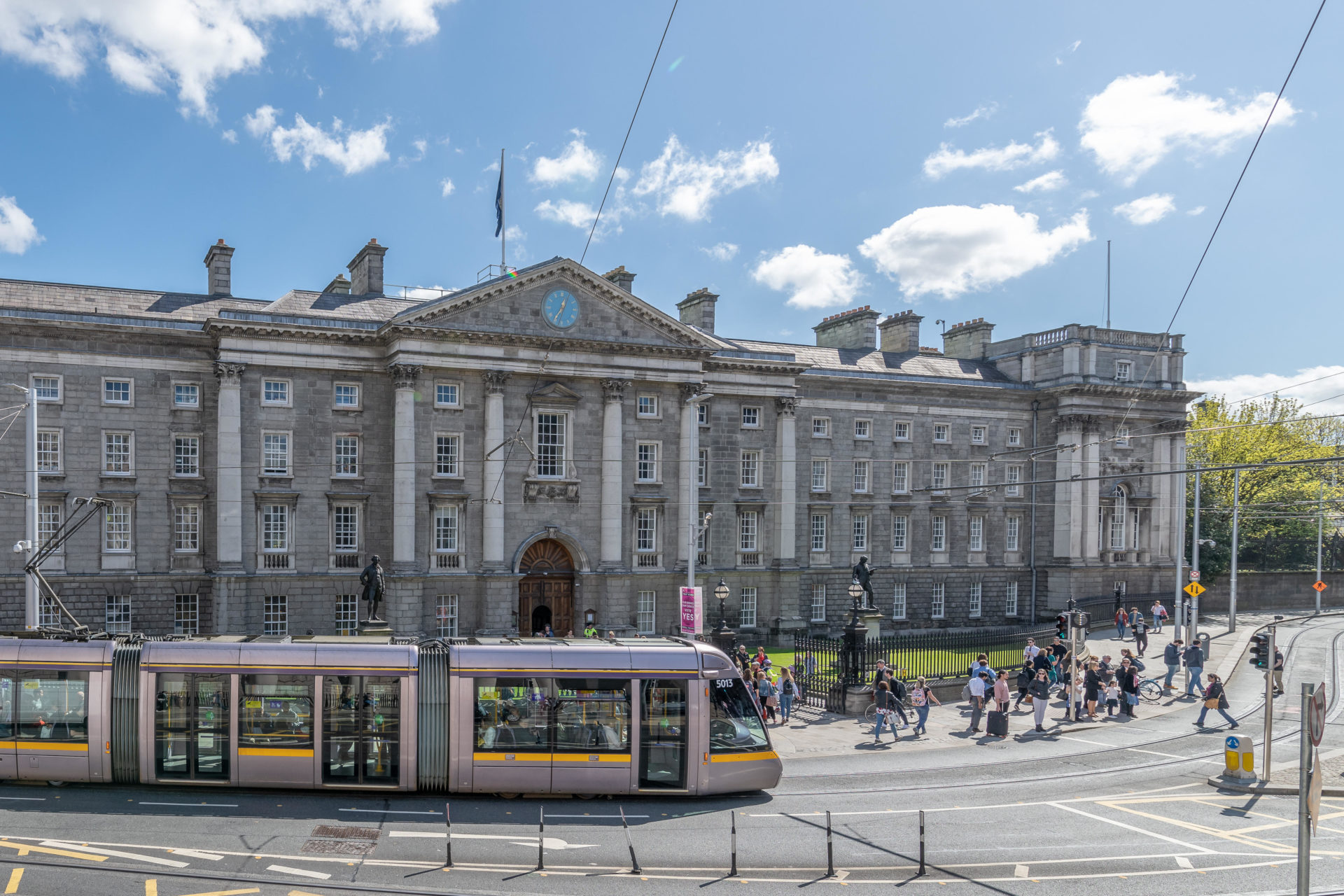 The Luas tram passes in front of Trinity College Dublin at College Green, Dublin , Ireland