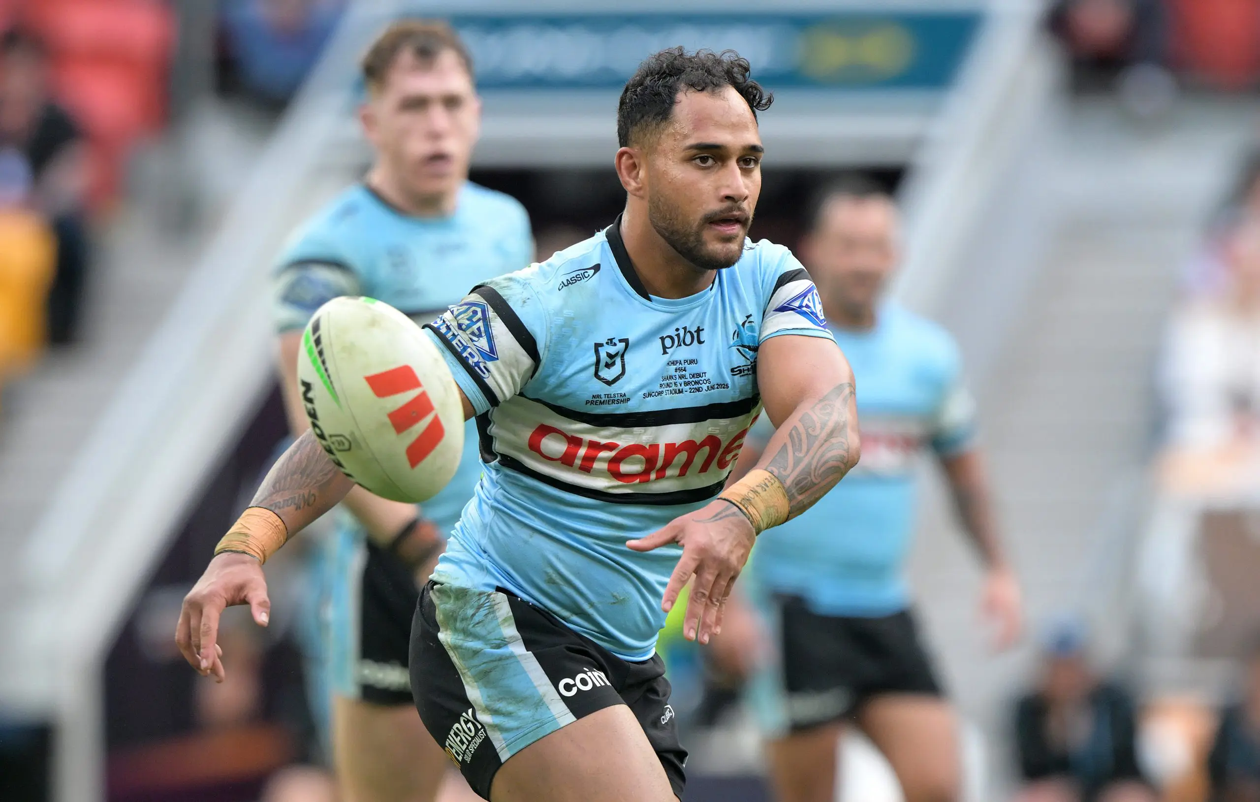BRISBANE, AUSTRALIA - JUNE 22: Hohepa Puru of the Sharks passes the ball during the round 16 NRL match between Brisbane Broncos and Cronulla Sharks at Suncorp Stadium, on June 22, 2025, in Brisbane, Australia. (Photo by Bradley Kanaris/Getty Images)