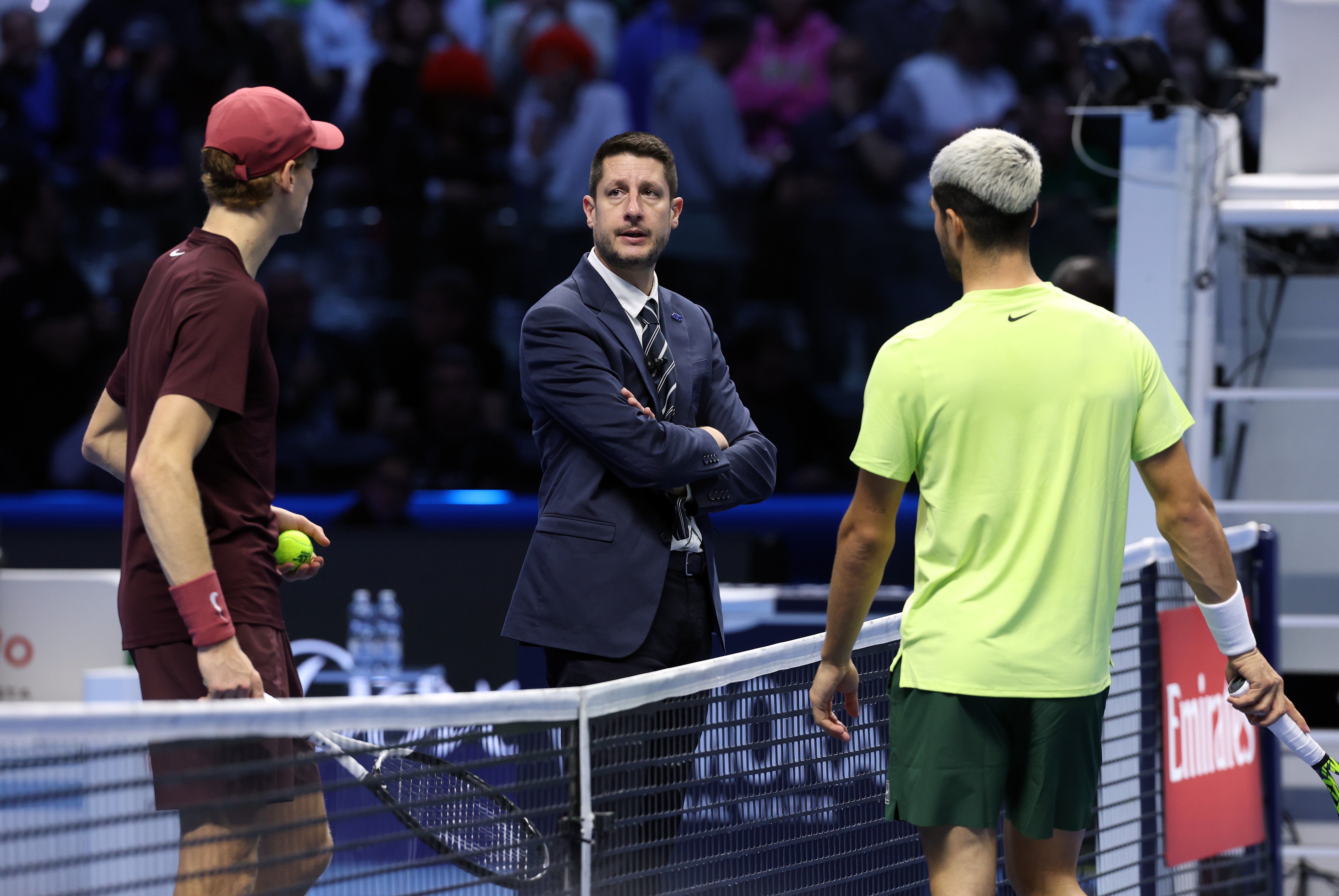 Jannik Sinner talks with Carlos Alcaraz umpire Renaud Lichtenstein during the delay
