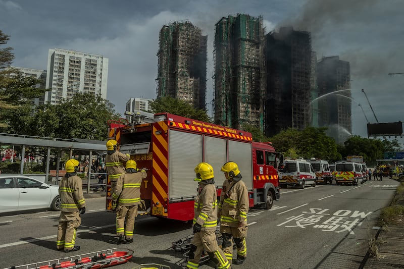 Firefighters and other emergency services at the scene. Photograph: Lam Yik Fei/The New York Times
                      