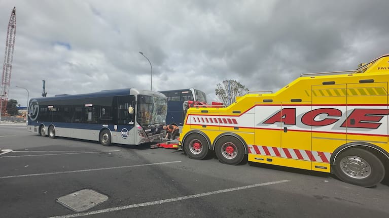 A bus is towed away with a smashed windscreen after a crash in Auckland this morning.