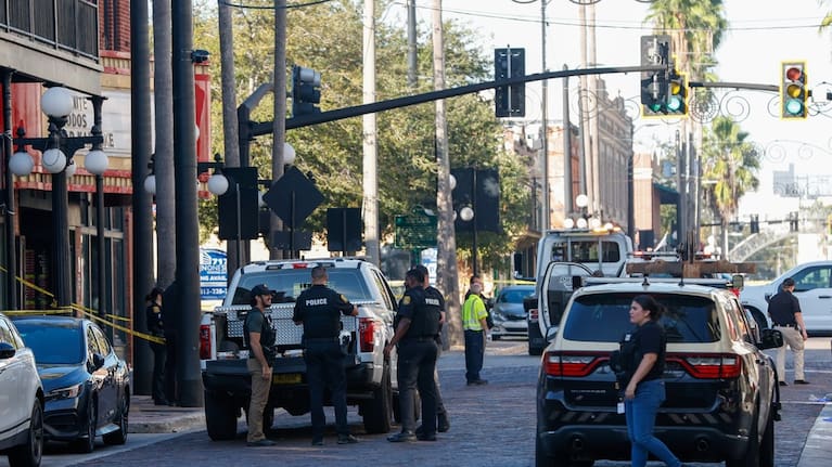 Law enforcement investigates the car crash scene on Saturday, November 8 in Tampa, Florida.