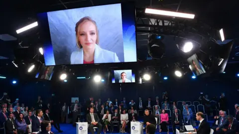 OLGA MALTSEVA/AFP Innopraktika development initiative head Katerina Tikhonova attends via videolink the Saint Petersburg International Economic Forum (SPIEF)