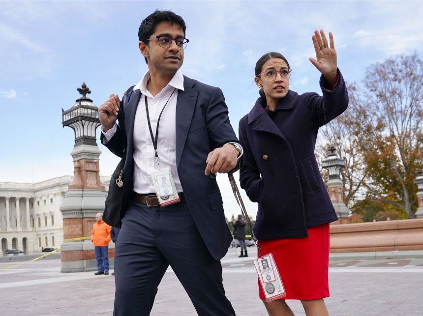 Rep.-elect Alexandria Ocasio-Cortez, D-NY., right, and her chief of staff Saikat Chakrabarti, left, walk back together after joining other members of the freshman class of Congress for a group photo on Capitol Hill in Washington on November 14, 2018.