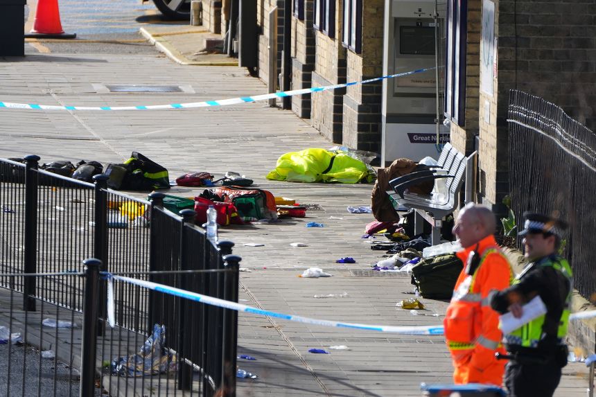 Belongings of escaping passengers are seen on the ground at the entrance to the Huntingdon train station on November 2 after a mass stabbing on a London-bound train.