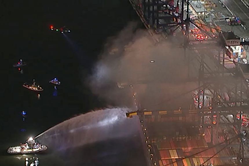 This image taken from video provided by ABC7 shows first responders battling a blaze on a container ship docked at the Port of Los Angeles on Friday.
